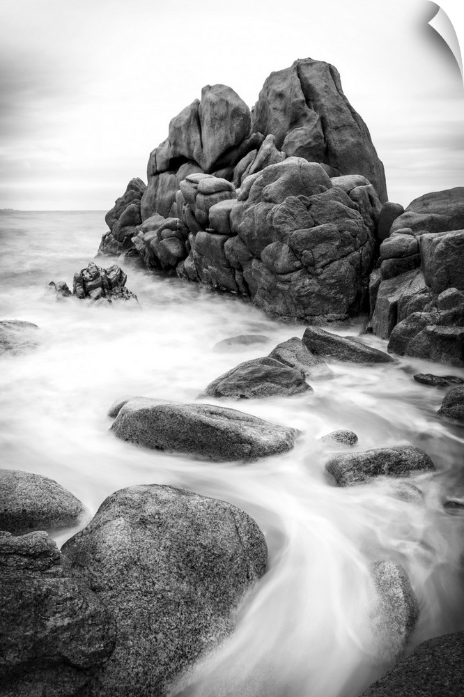 A black and white photograph of a rocky coastline.