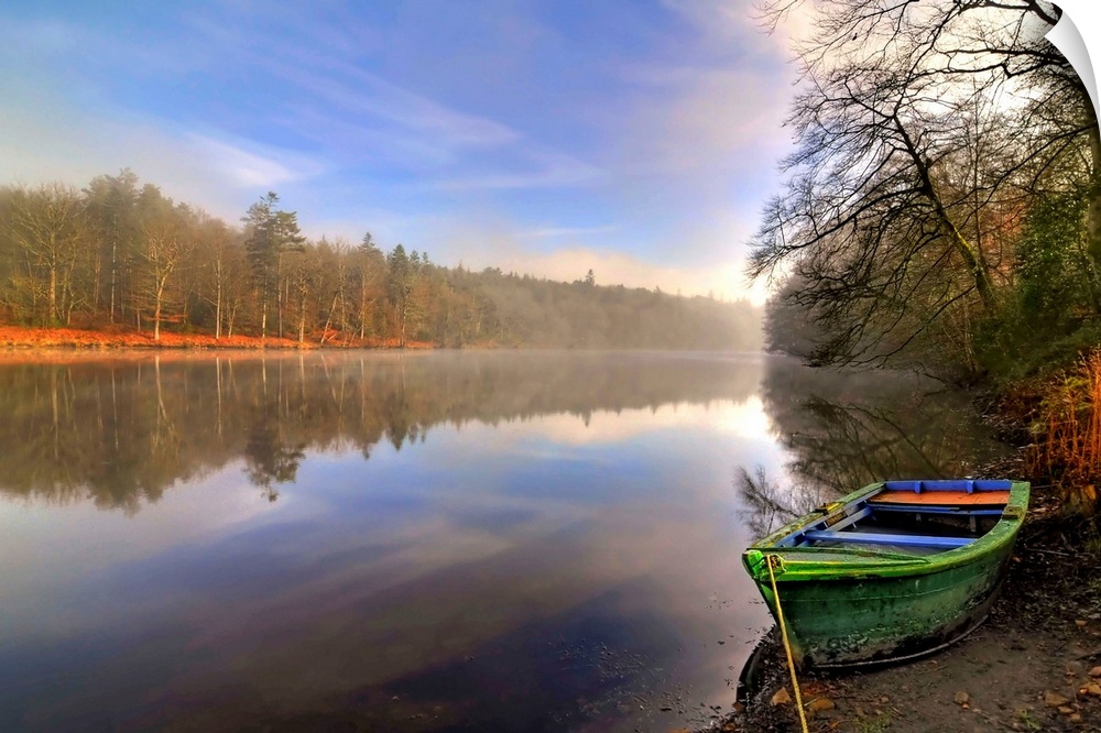 Quite lake in the Broceliande forest with a colored boat on the side in France, Broceliande forest, Brittany.