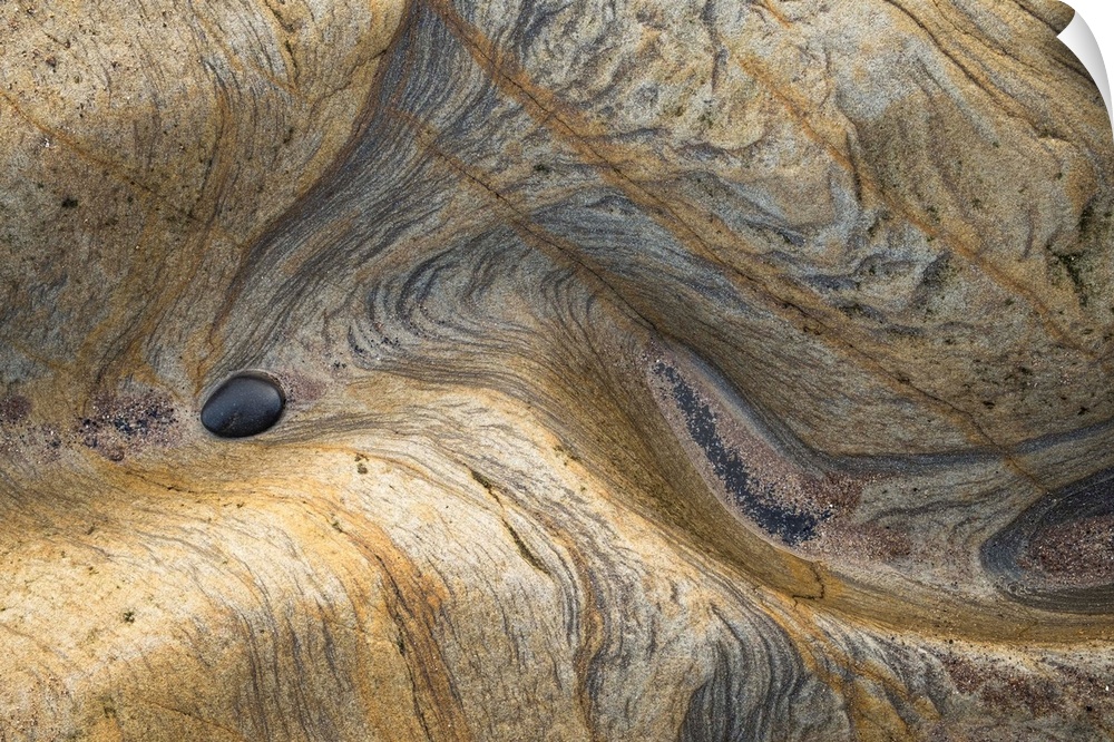 Abstract photograph of a rocky surface displaying all its layers of age and experience.