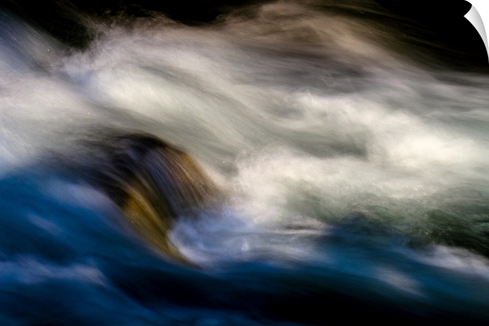 A photo of rushing water with foam that has been edited to a smooth effect.