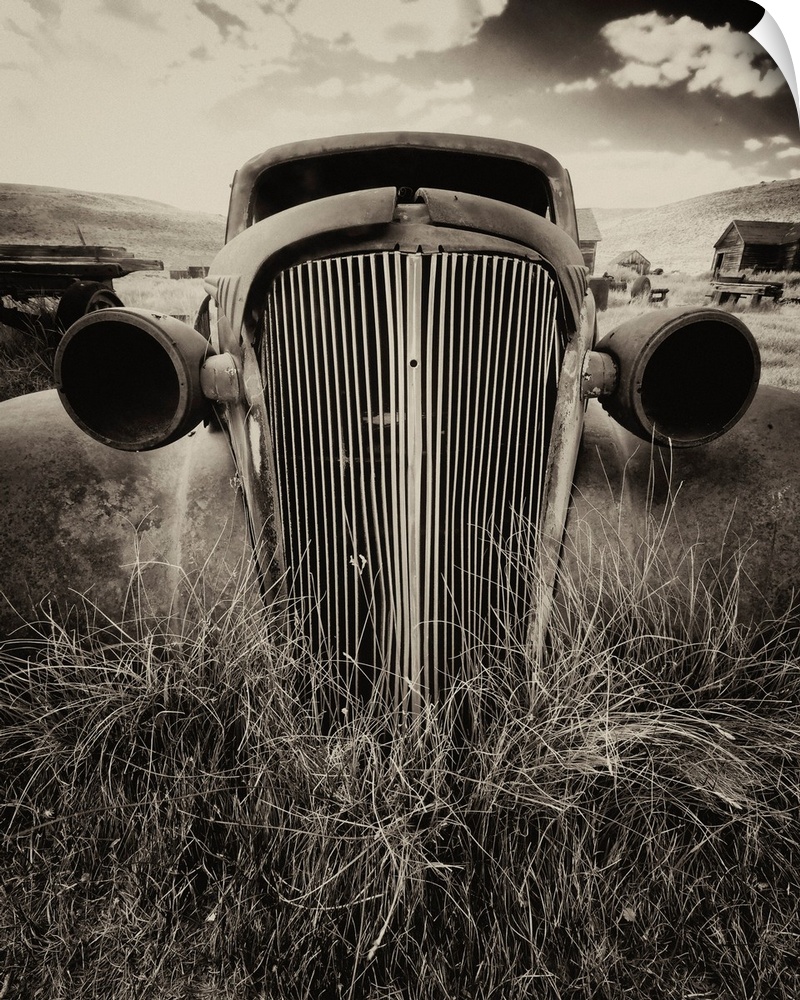 Close up frontal view of a rusting classic car in sepia tones, Bodie, California.