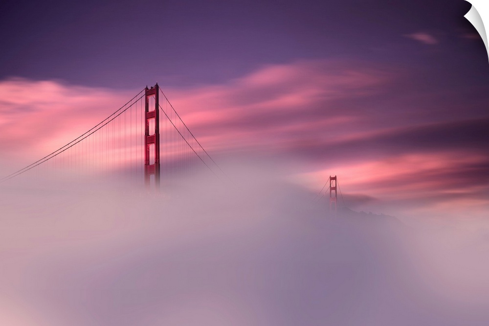 A sunset obscured by dense fog and the Golden Gate Bridge rising out of the mist in this landscape photograph.