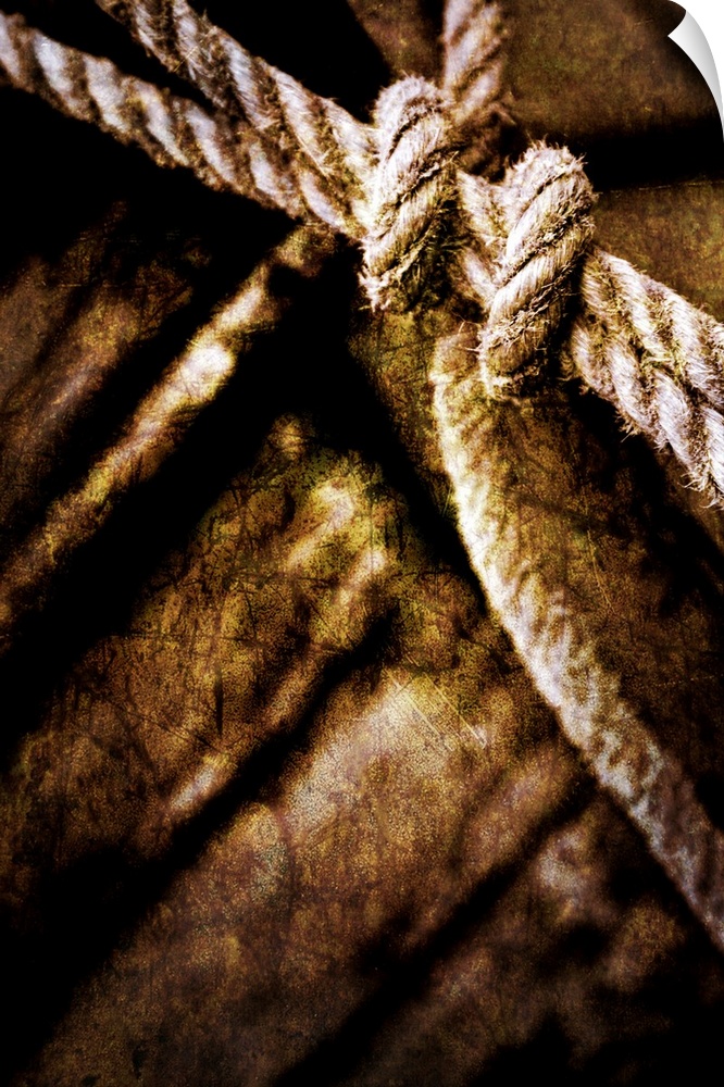 This fine art photograph of a knot tied and out of focus wood planks in the background. This photograph has had several ar...