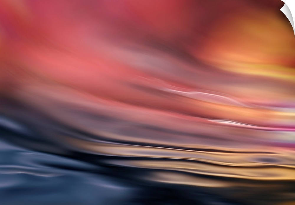 Abstract photograph of softly rippling water in red and orange tones.