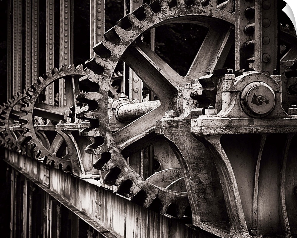 A photograph of a set of large old looking gears that operate a gate.