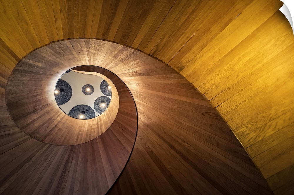 View through the center of a spiraling staircase from below.