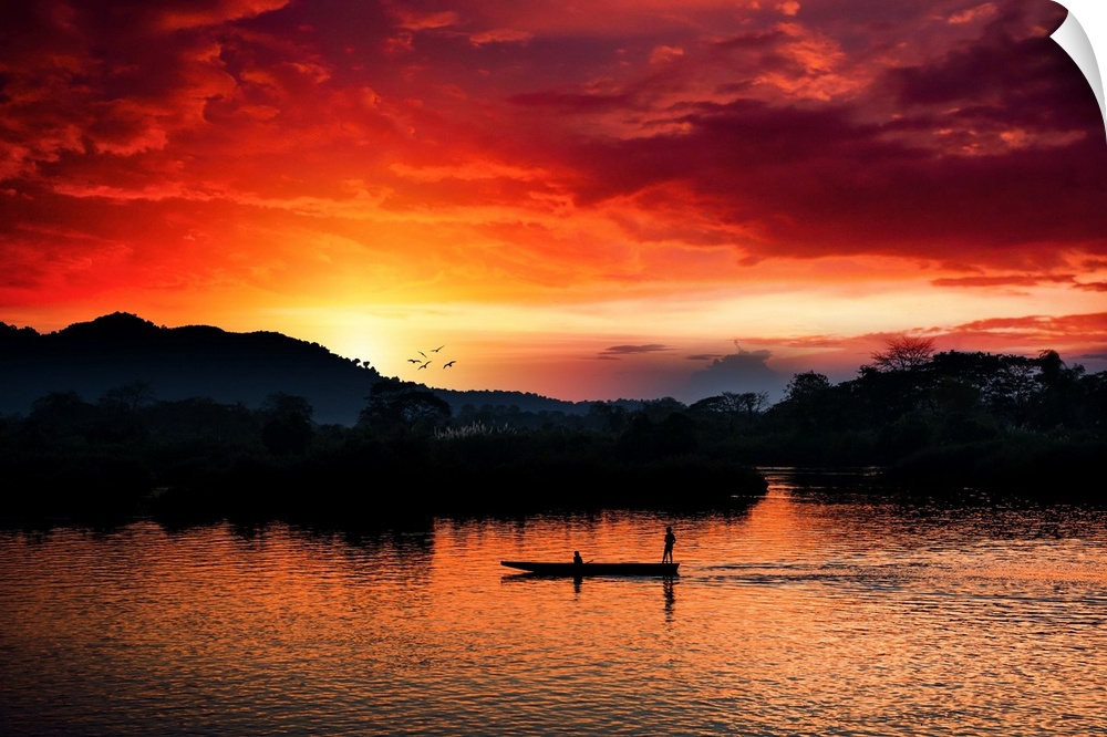 Red sunset over the Mekong with a boat in the foreground