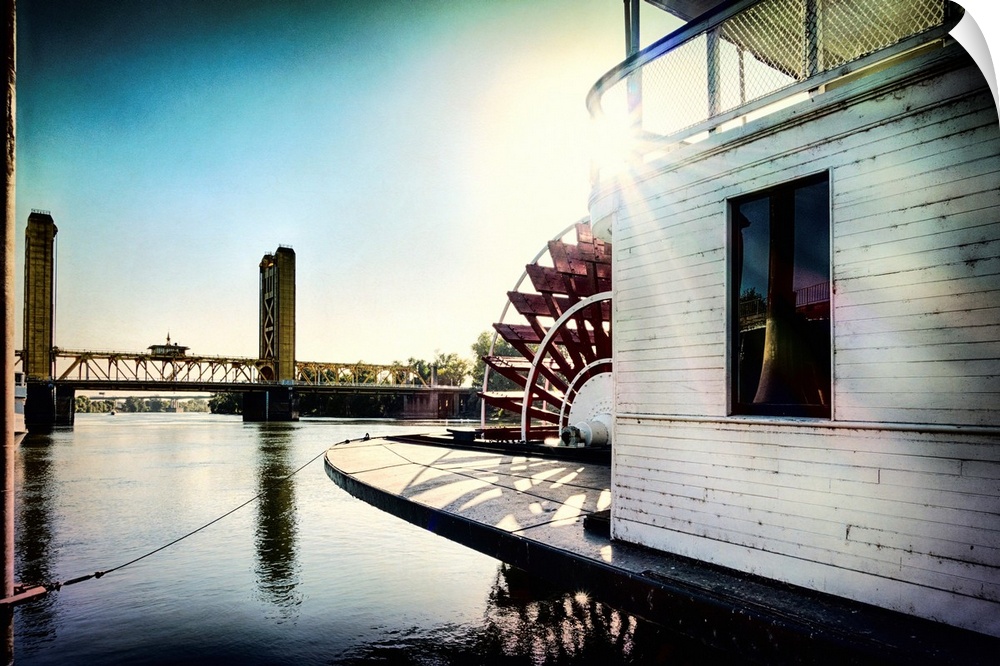 A vignette photo of a steamboat and a drawbridge.