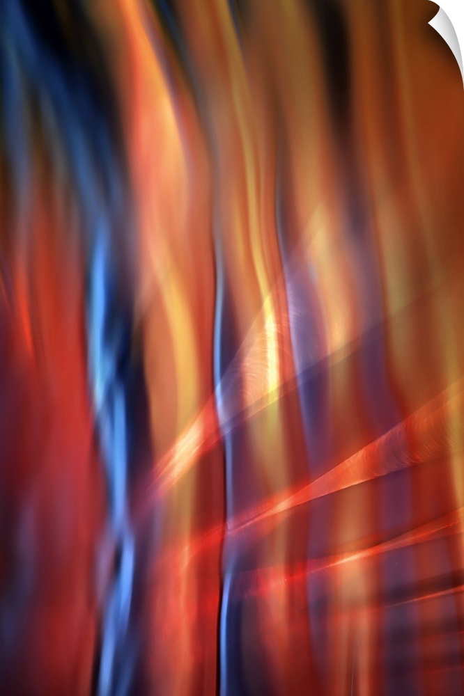 Abstract photograph of blurred and blended colors and flowing lines, with blue and orange waves.