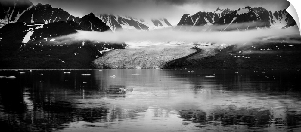 Black and white photograph of a glacer and mountains in Svalbard, Norway.