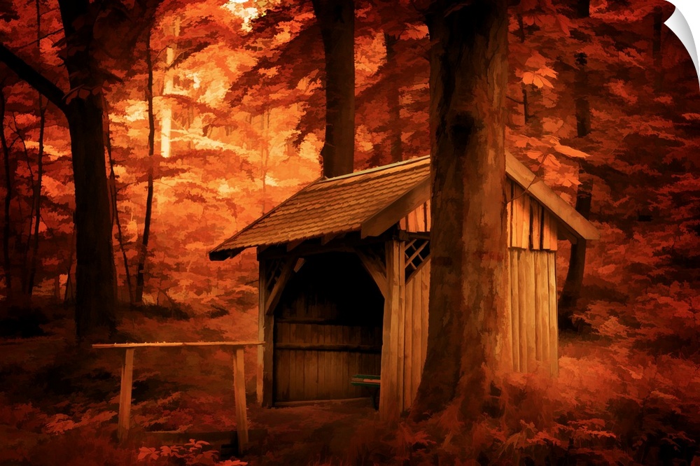 A photograph of a stable surrounded by trees in autumn foliage.