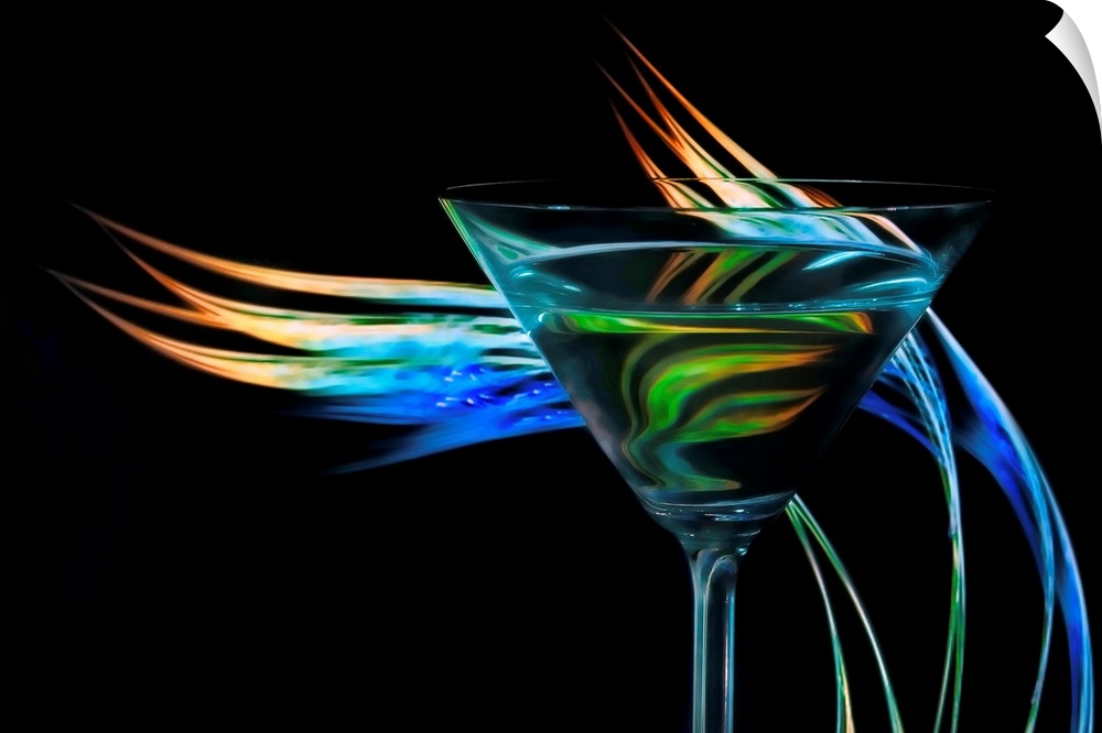 Up-close photograph of a martini glass with colorful waves of light behind it.