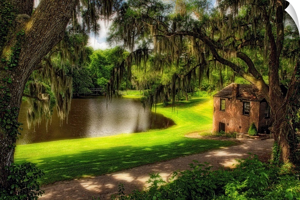 Fine art photo of a small house near a river in a mossy forest in South Carolina.