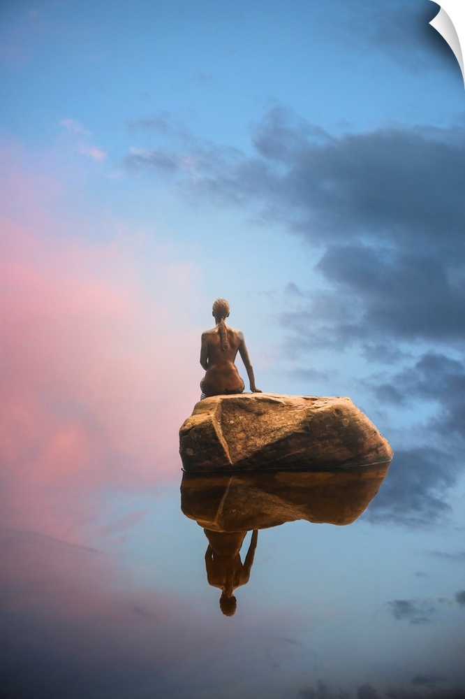 Sculpture of a woman reflected in the water