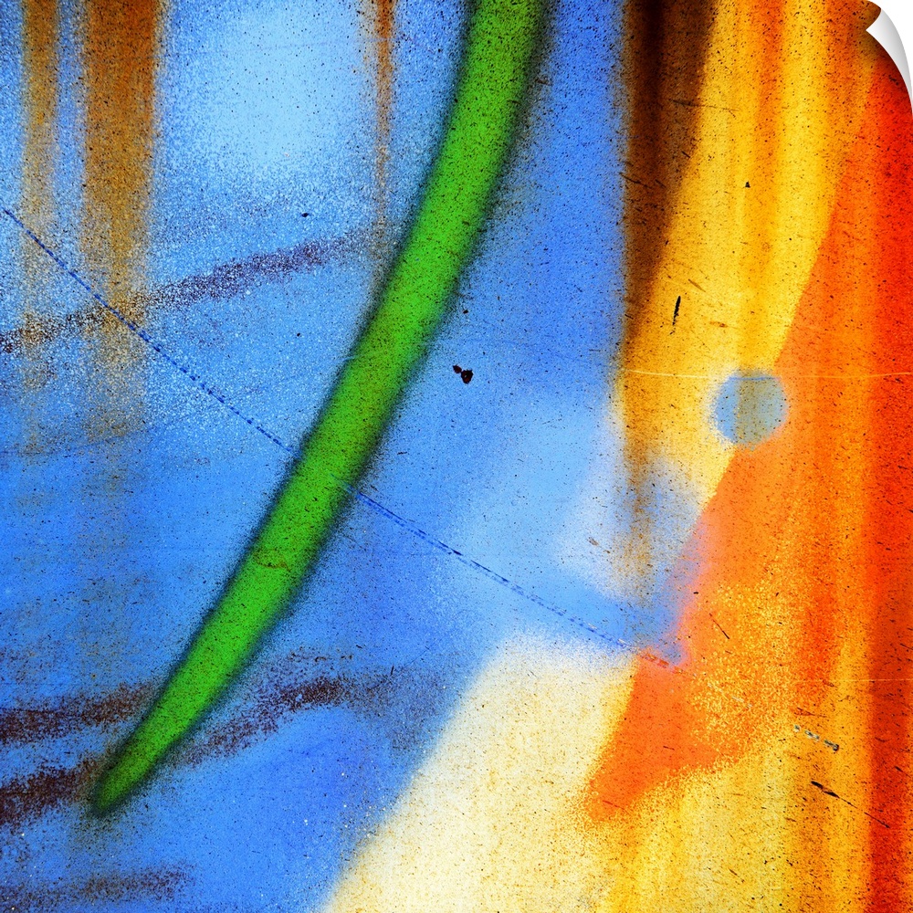 Abstract artwork created from a close up shot of graffiti on a wall, with curved streaks of blue, green, and orange.
