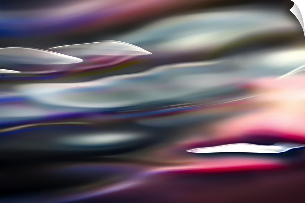 Abstract photograph in pink and blue shades resembling ocean waves.