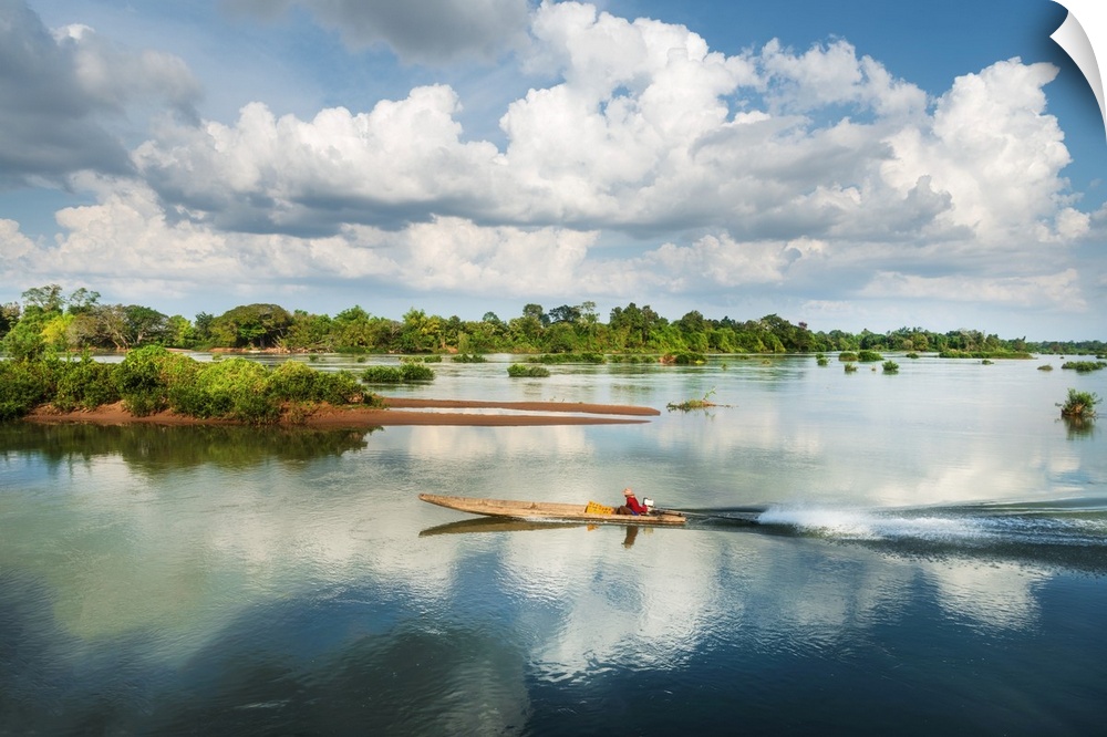 A fisherman in a boat on the Mekong in Laos