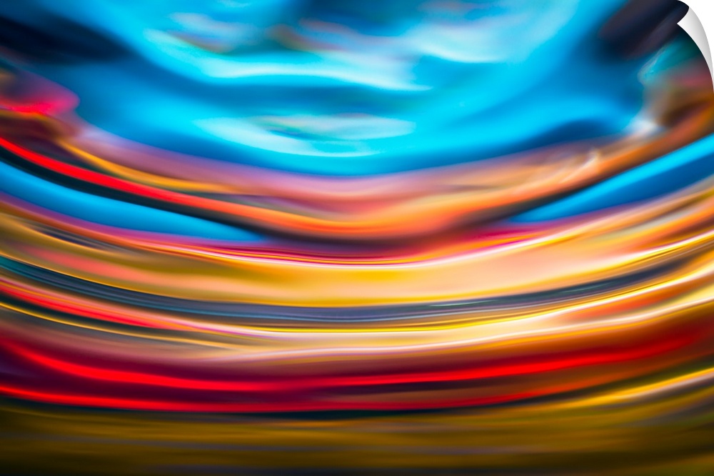 Abstract photograph with arched lines in hues of yellow, red, and blue.