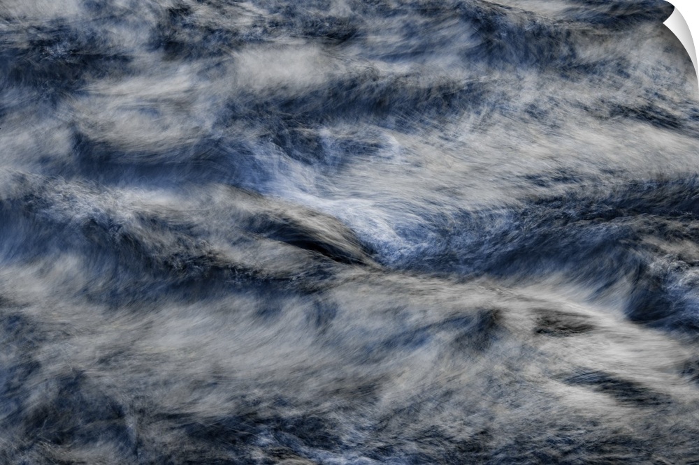 A contemporary natural abstract of deep silvery blue rushing water swirling around the frame.