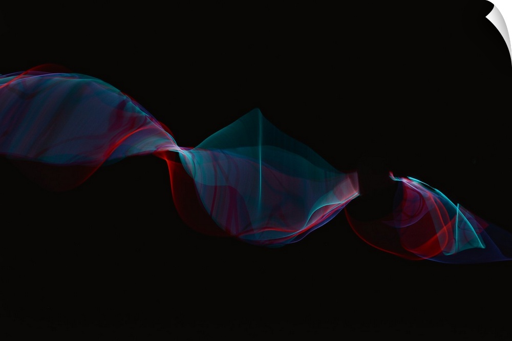 Abstract image created by trailing blue and red lights, resembling wisps of smoke.