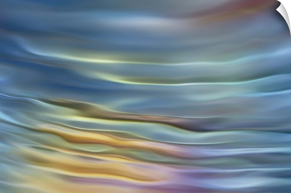 Abstract photograph in pastel yellow and blue shades resembling ocean waves.
