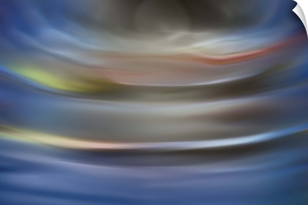 Abstract photograph in grey and blue shades resembling ocean waves.