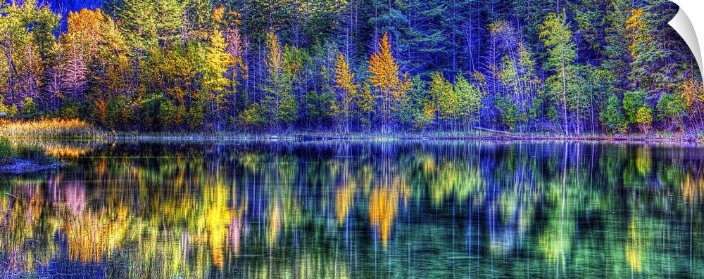 A colorful scene of fall trees reflecting on the water.