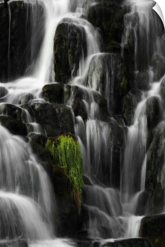 Fine art photo of a waterfall over several round rocks