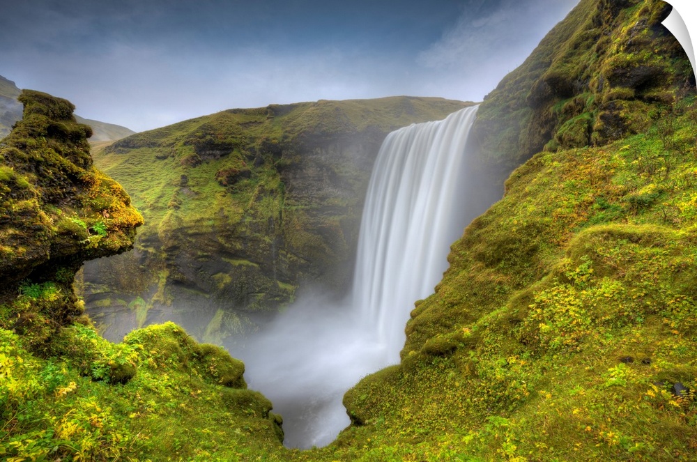 Fine art photograph of a waterfall in Iceland surrounded by mossy rocks.