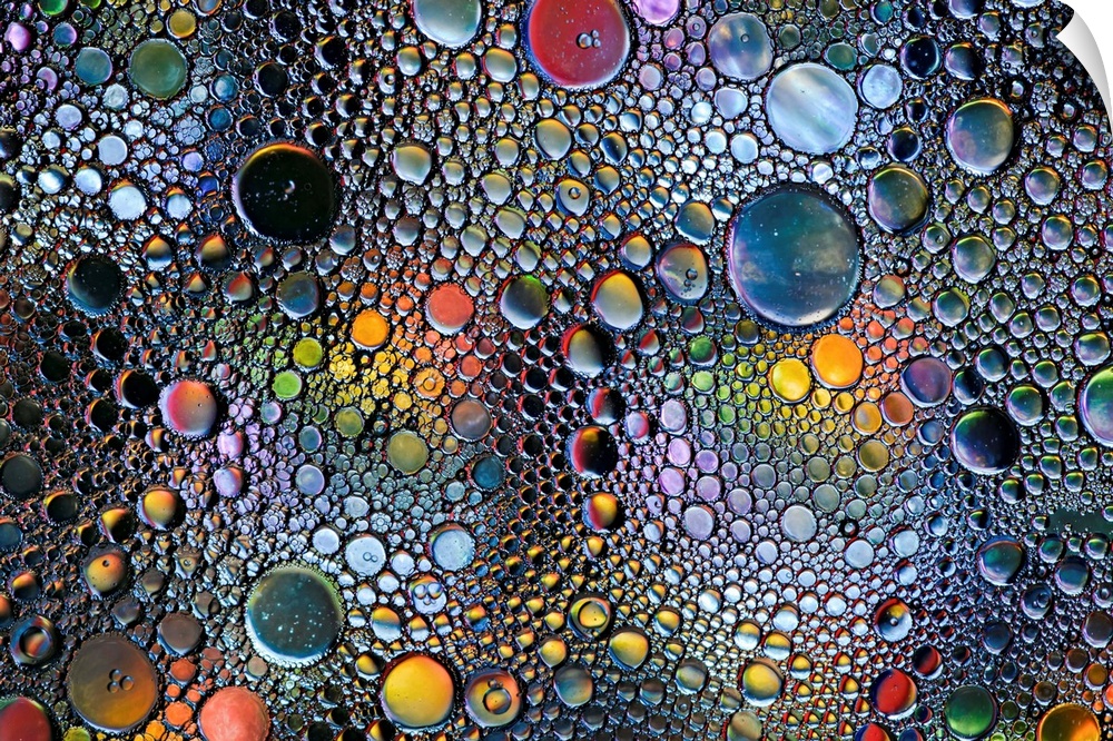 Abstract photo of a multitude of bubbles in rainbow colors of different sizes.