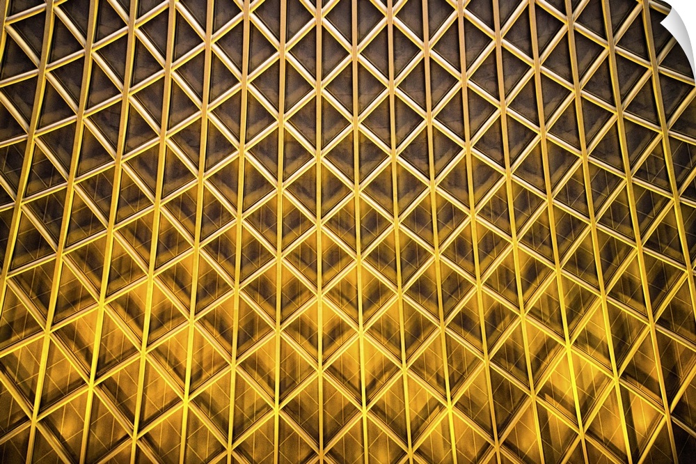 A photograph of an abstract view of gold patterned architectural details.