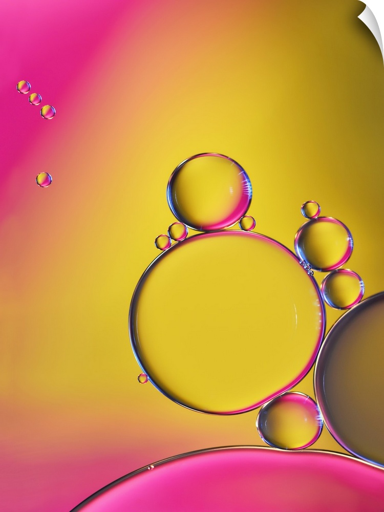 A macro photograph of a cluster of bubbles against a colorful background.