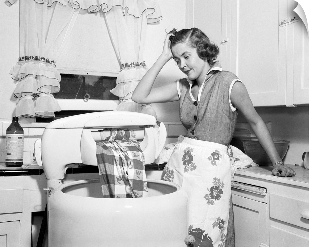 1950s Frustrated Housewife With Jammed Wringer On Clothes Washing Machine In Kitchen.