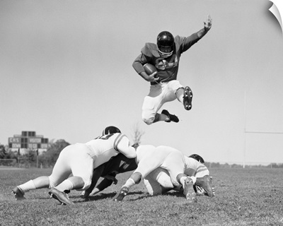 1960's Football Player Jumping Over Blocked Players