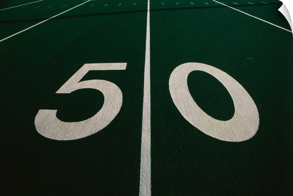 Wall art of the fifty yard line of a football field.