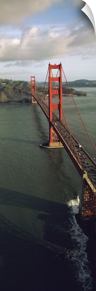 This tall vertical panoramic picture is taken from above the Golden Gate Bridge looking down the road as it crosses onto l...