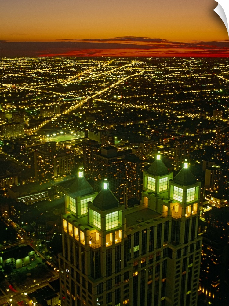 Canvas photo art of a cityscape seen from above lit up at sunset.