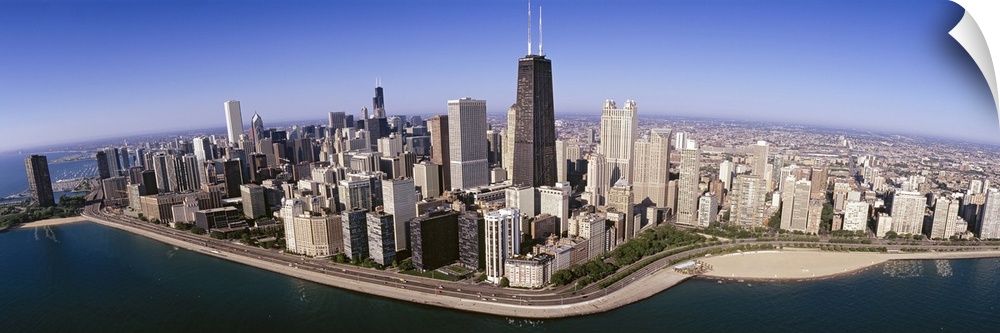 This wide angle photograph was taken from above the Chicago skyline over Lake Michigan that lines the coast of the city.