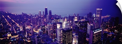 Aerial view of buildings in a city lit up at dusk, Chicago, Illinois