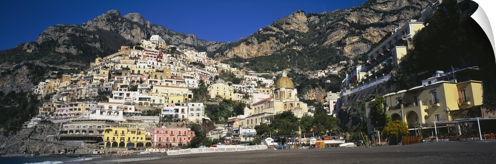 View from below of the buildings stacked upon the hill off the Amalfi Coast in Positano, Italy.