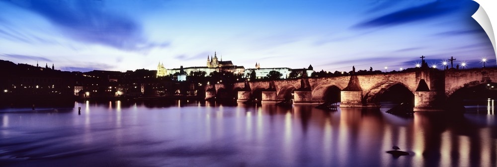 Arch bridge across a river with a cathedral in the background, St. Vitus Cathedral, Hradcany Castle, Vltava river, Prague,...