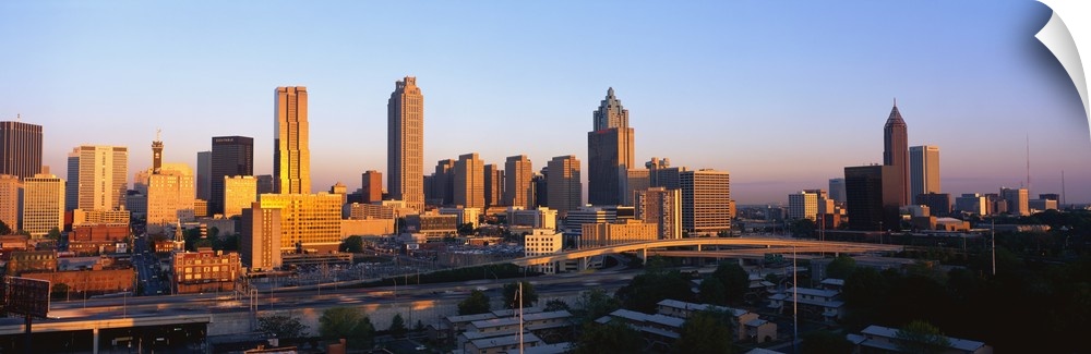Large, panoramic photograph of the Atlanta, Georgia skyline at sunrise.