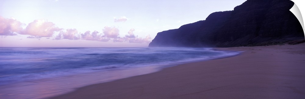 Serene panoramic photograph of a Hawaii beach at dusk in soft cooler tones.