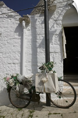 Bicycle parked against a pole, Trulli House, Alberobello, Apulia, Italy