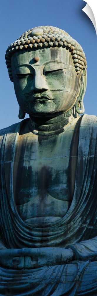Only part of a Buddha statue is photographed for this tall panoramic piece.