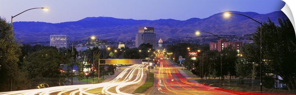 Panoramic photograph taken of a major highway in Boise with the lights of the cars shown as streaks on the road.
