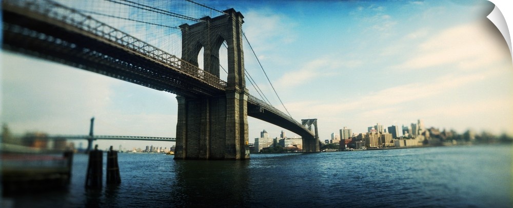 This elongated piece is a photograph taken of the Brooklyn Bridge from the Manhattan side.