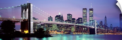 Bridge across a river lit up at dusk, Brooklyn Bridge, East River, World Trade Center, Wall Street, Manhattan, New York City, New York State