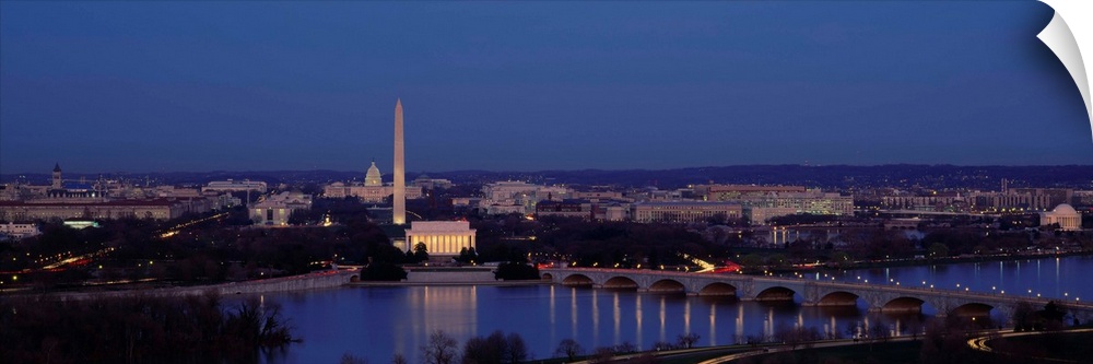Panoramic shot taken of Washington DC with the Washington monument most noticeable and a river shown in front of it.