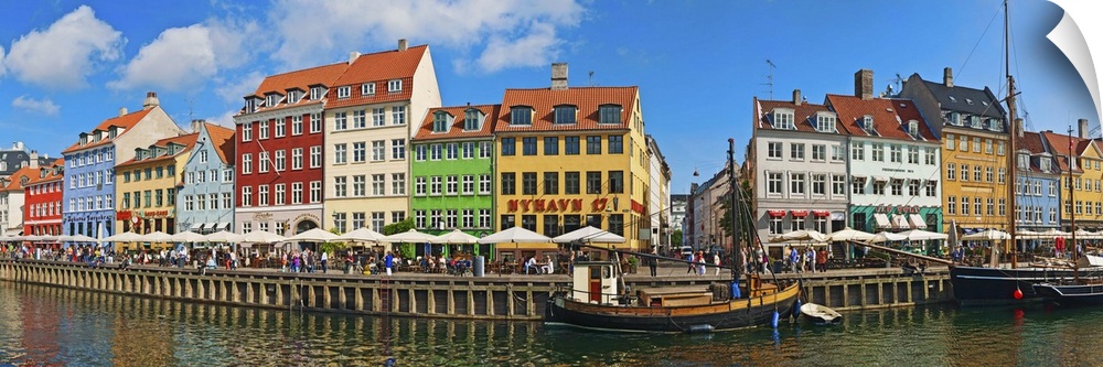 Buildings along a canal with boats, Nyhavn, Copenhagen, Denmark